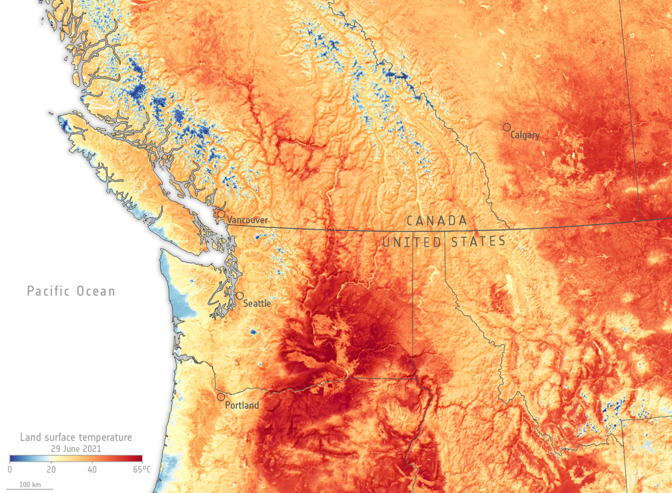 Satellite image map shows US-Canada border including Vancouver and Calgary, Seattle and Portland, and heat map shows land surface temperatures up to 65 degrees