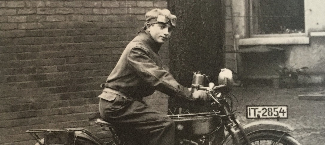 Black and white photo of Mac Goldsmith on motorbike in 1920