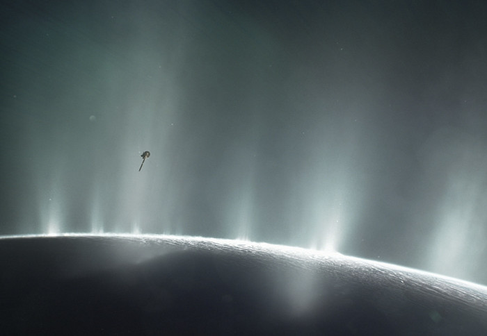 Spacecraft flying through illuminated plumes of material above a moon's surface