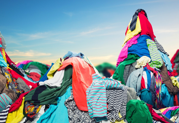 A mound of clothes in a landfill site