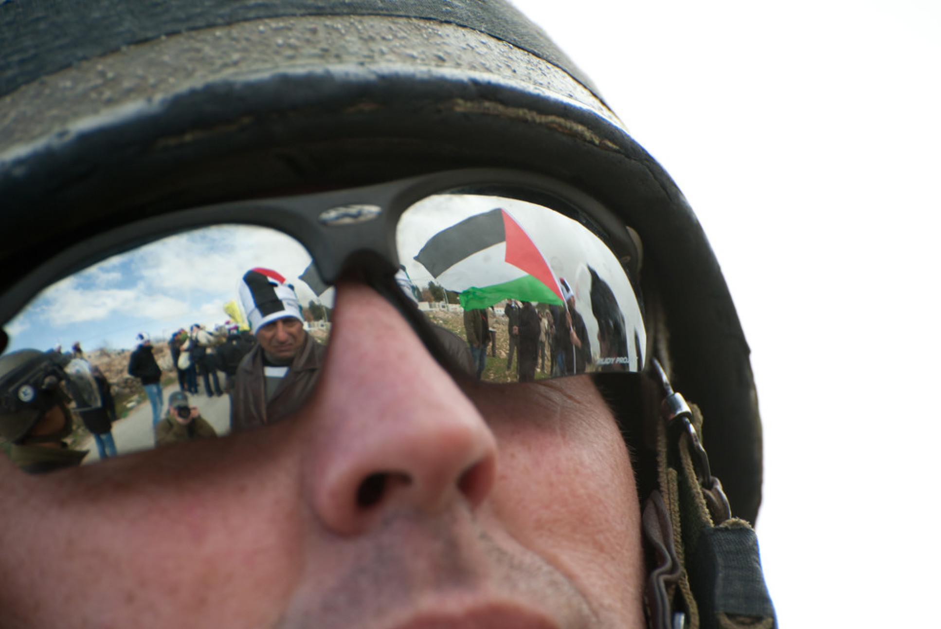 An Israeli soldier encounters Palestinian protestors