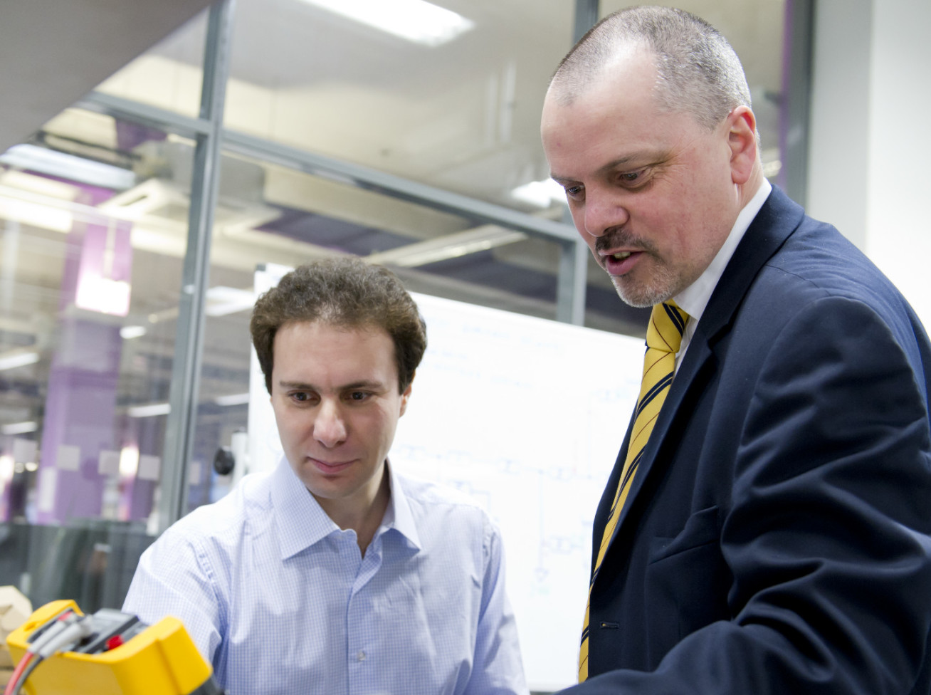 Professor Tim Green shows a colleague technical equipment