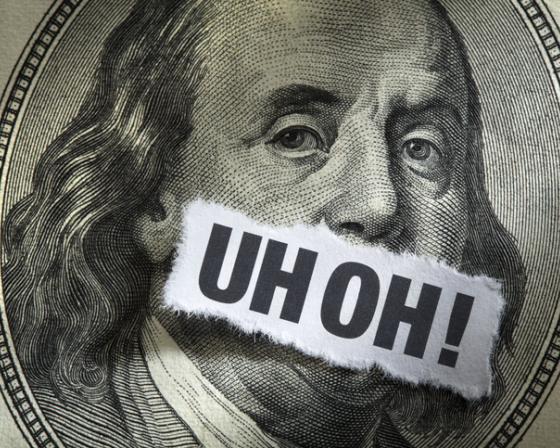 A $100 bill with the words "Uh Oh!" over Benjamin Franklin's mouth