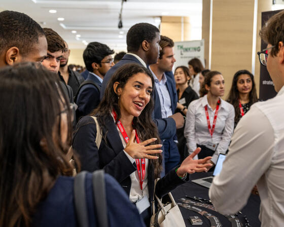 A student chatting to a company at the Imperial College Business School Careers Fair