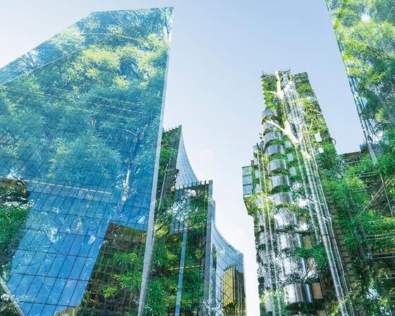 View from bottom of Tall skyscrapers, looking up to the sky, an image of a forest overlays the buildings, appearing to 'reflect' greenery