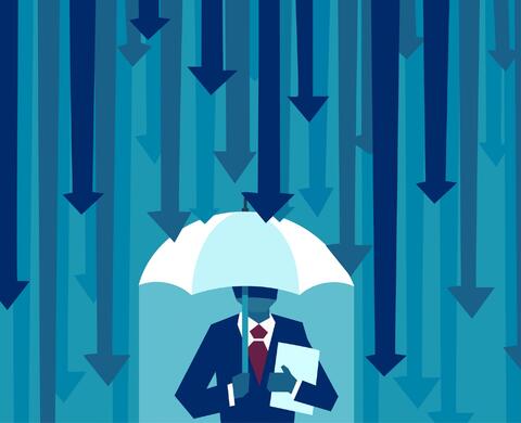 Businessman with umbrella protecting himself from falling arrows