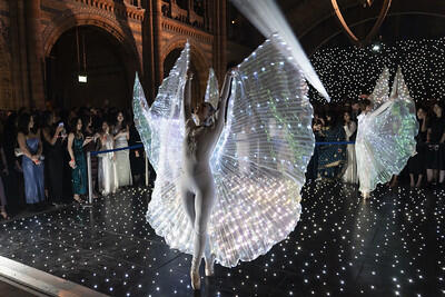 Ballet performers, with LED fairy wings dance at Natural History Museum Party 2024