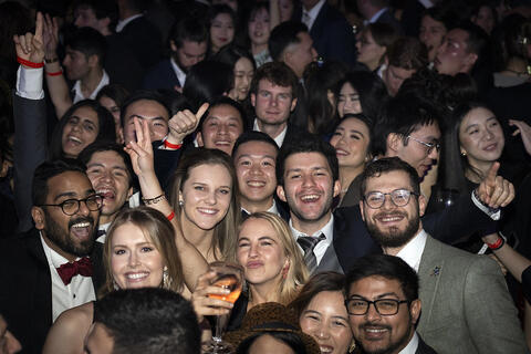 Students smiling and partying at Natural History Museum