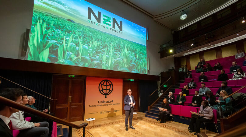Undaunted lecture - presenter in front of green reading Net Zero Nitrogen
