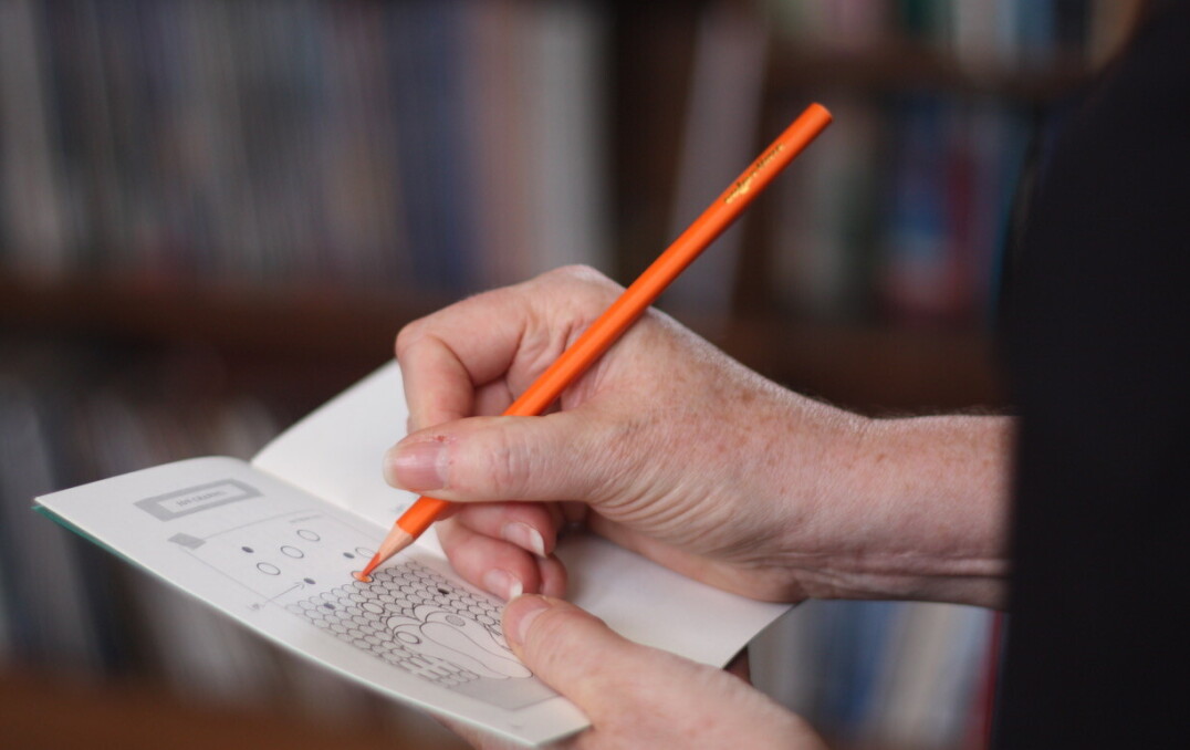 person writes on pad