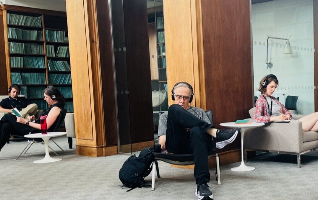 People sit and listen in library