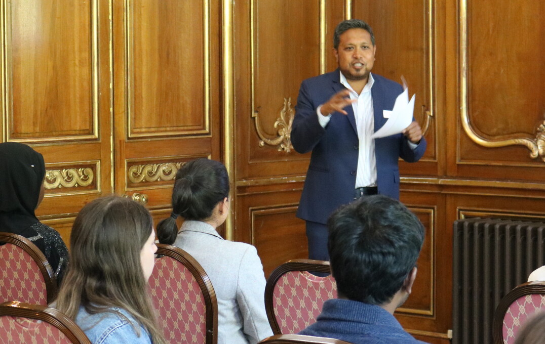 Person introduces event to seated people