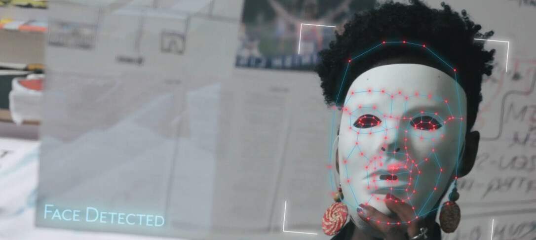 Refection of a person wearing a face detection white mask