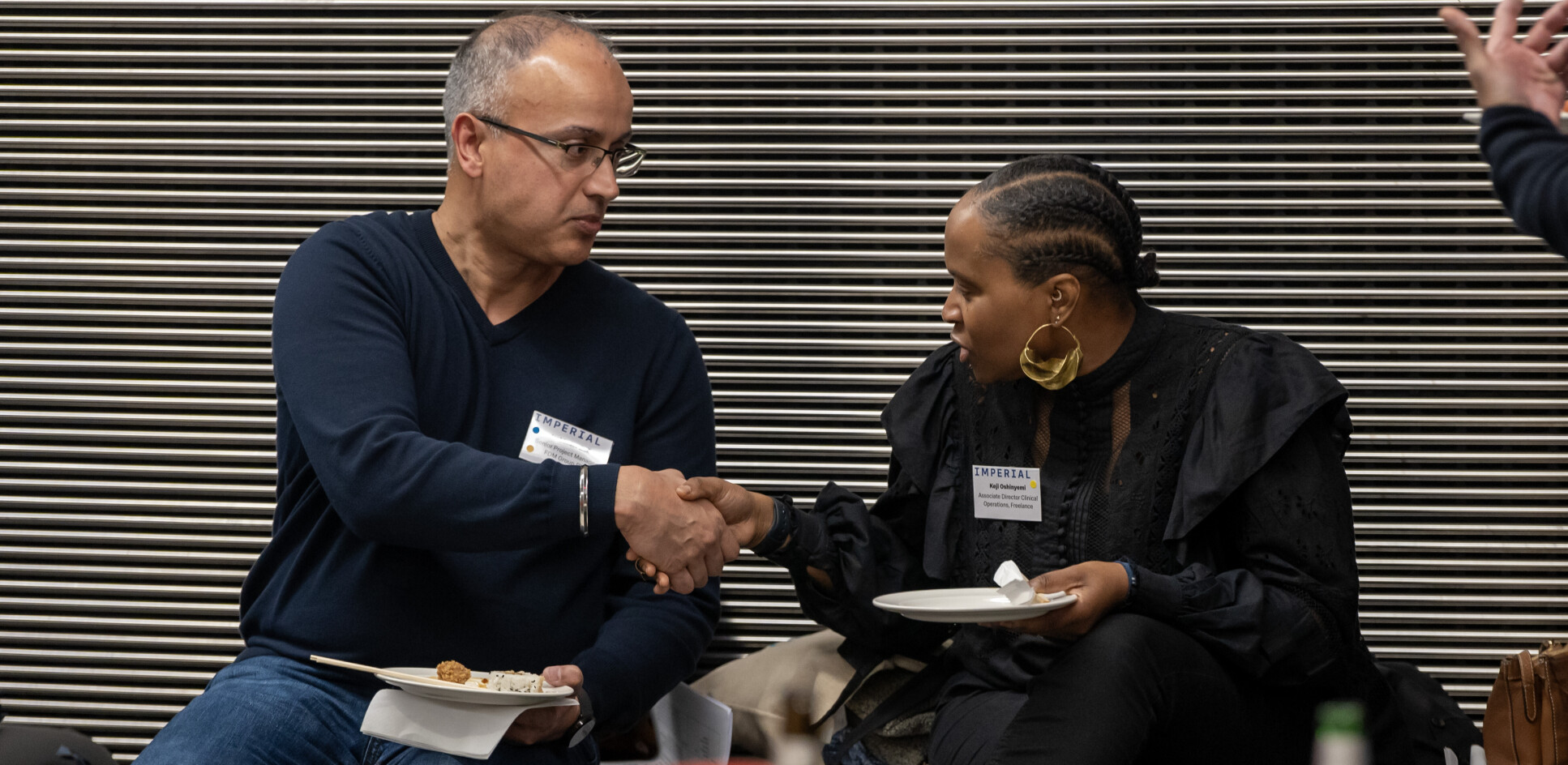 Alumni shaking hands at the event