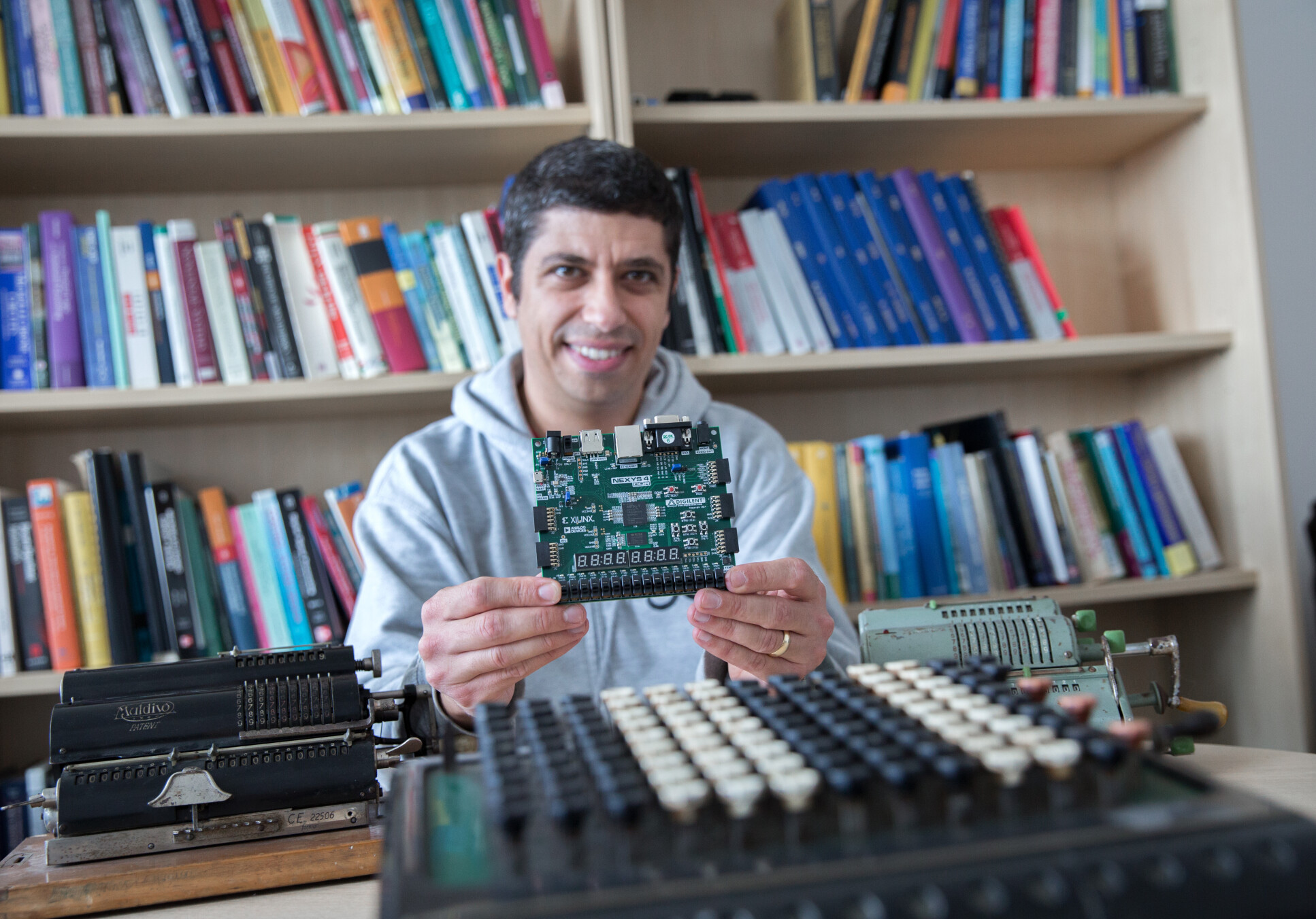 Professor George Constantinides holding up a computer board