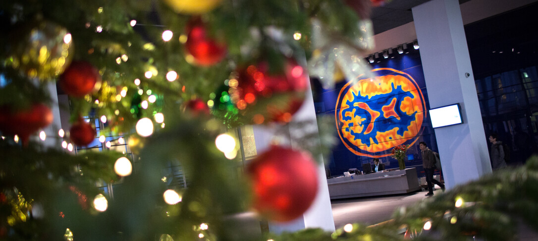 Close up of lights and baubles on Christmas tree with Imperial main entra