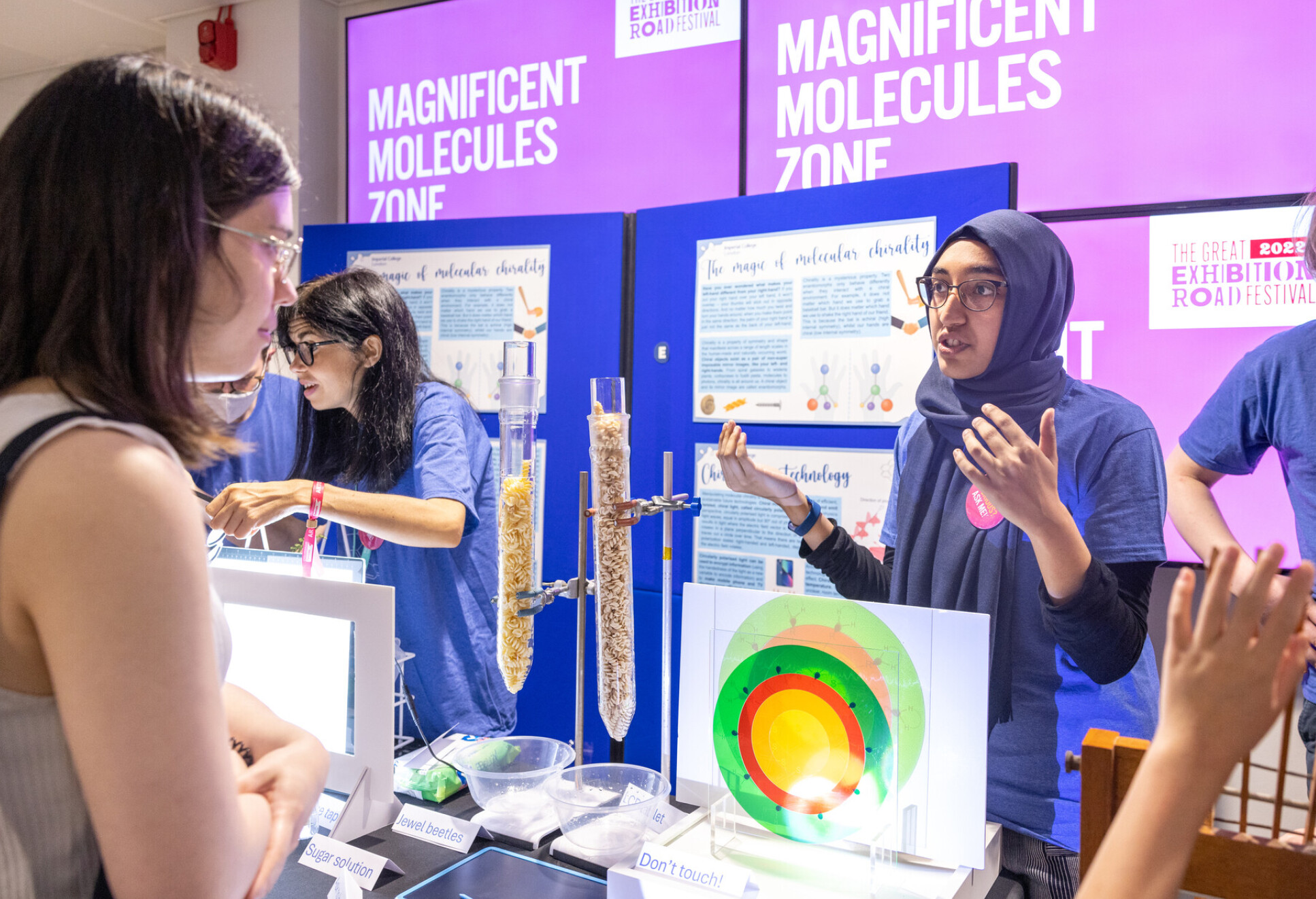 Female researcher talking to member of the public at the Great Exhibition Road Festival