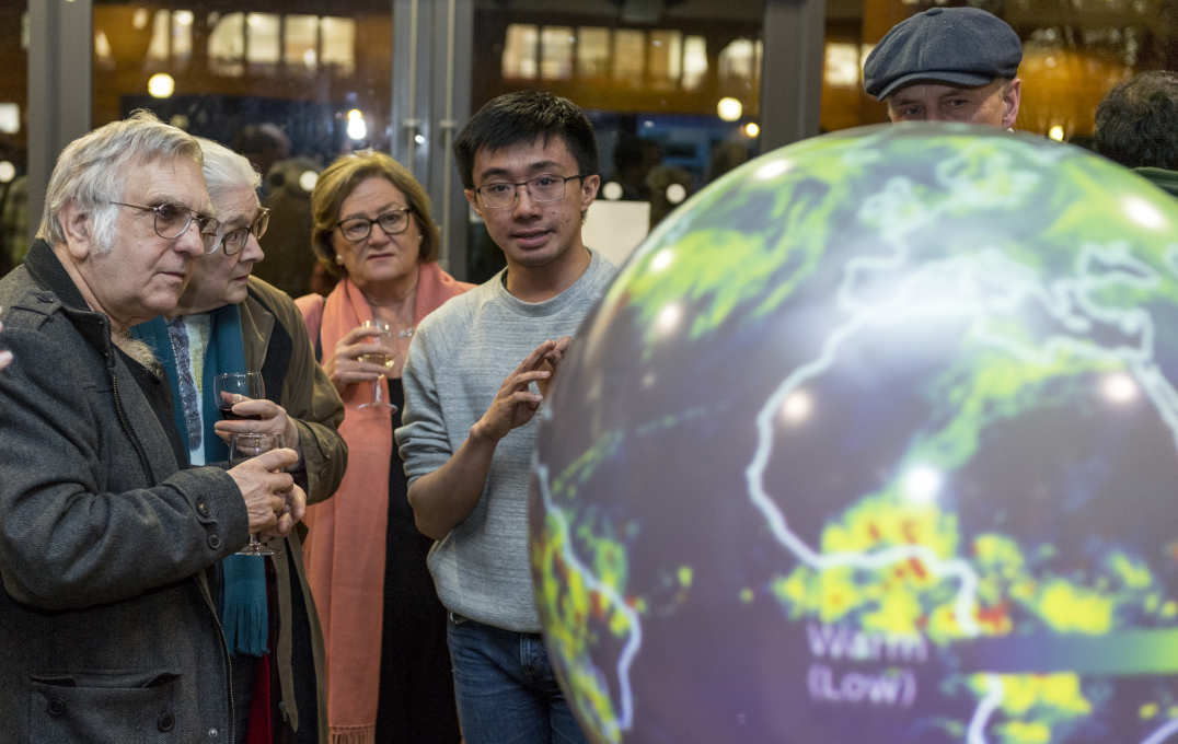 People look at a digital globe