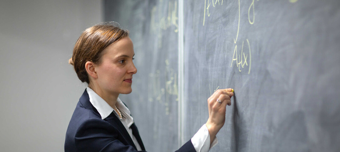 Professor Almut Veraart writing on blackboard