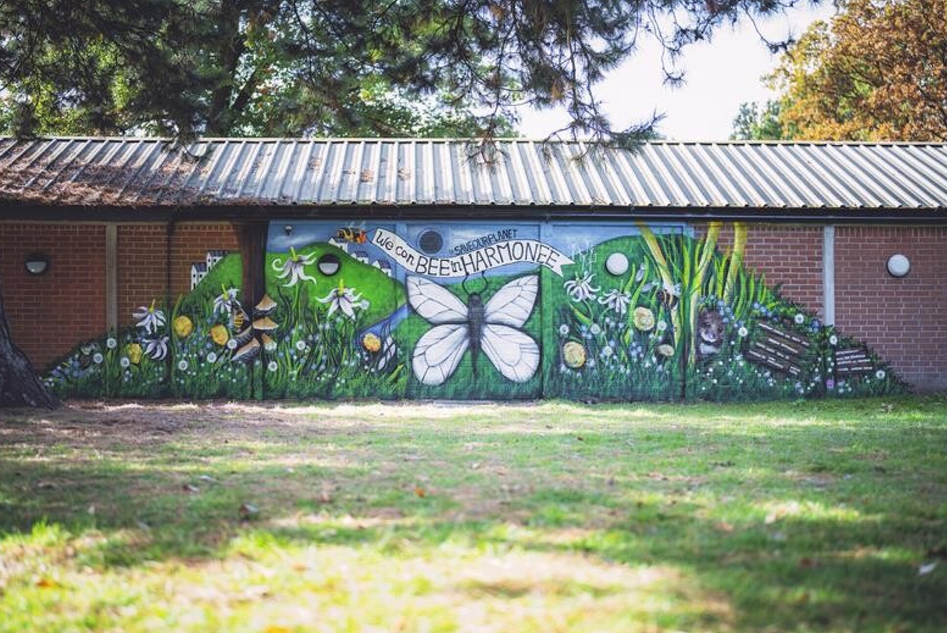 Mural eaturing a sustainable landscape bursting with plant life and pollinators