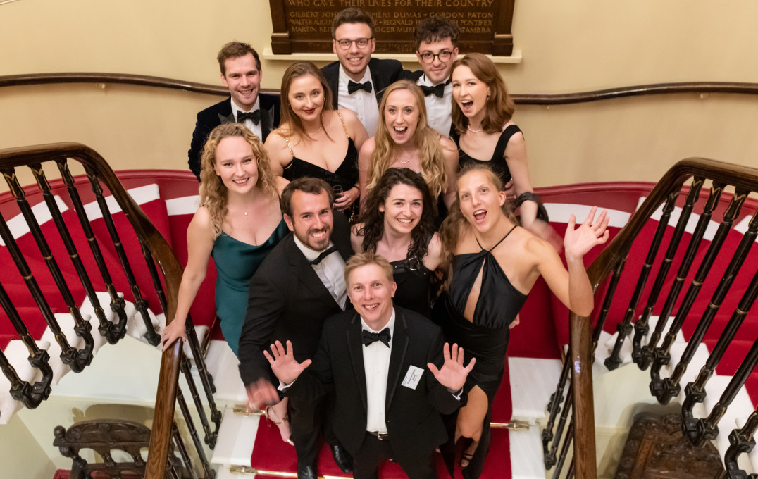 Alumni on the stairs of the Armourers Hall