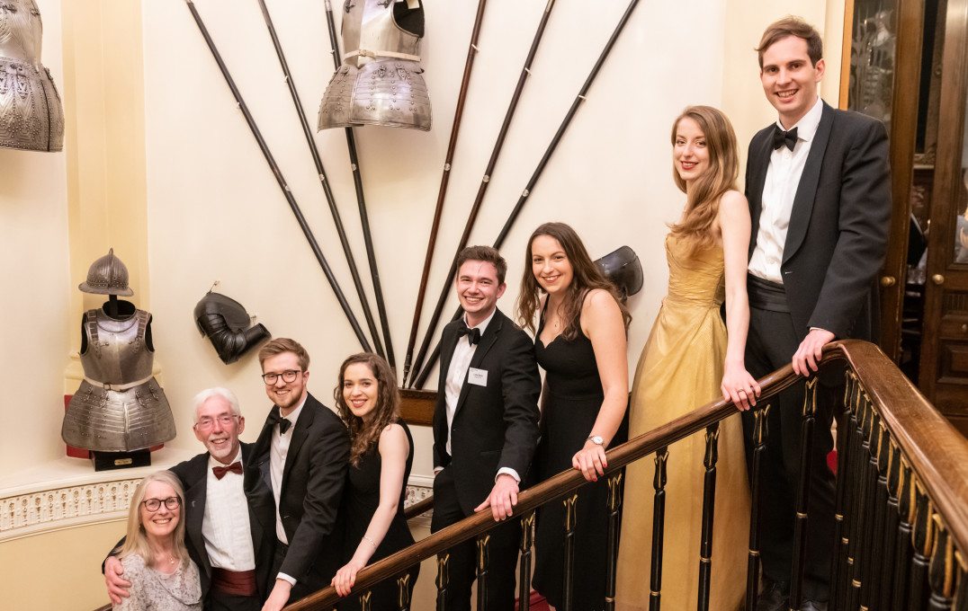 Alumni on the stairs of the Armourers Hall