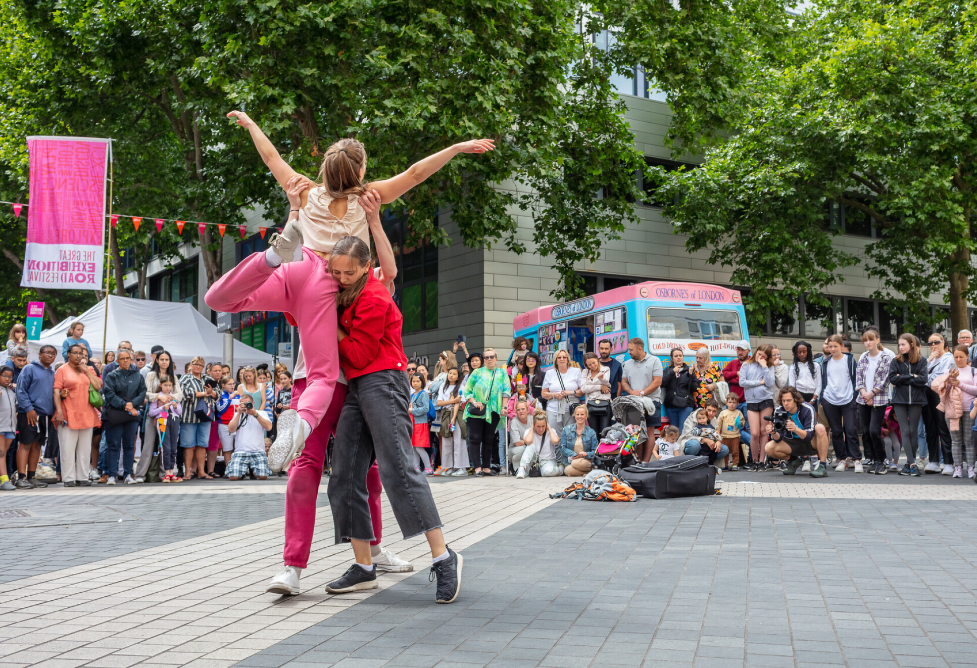 Two dancers performing on the street for a crowd at the Great Exhibition Road Festival