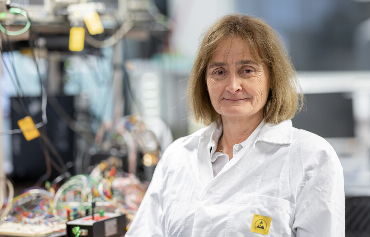 Michele Dougherty smiles at the camera wearing a lab coat