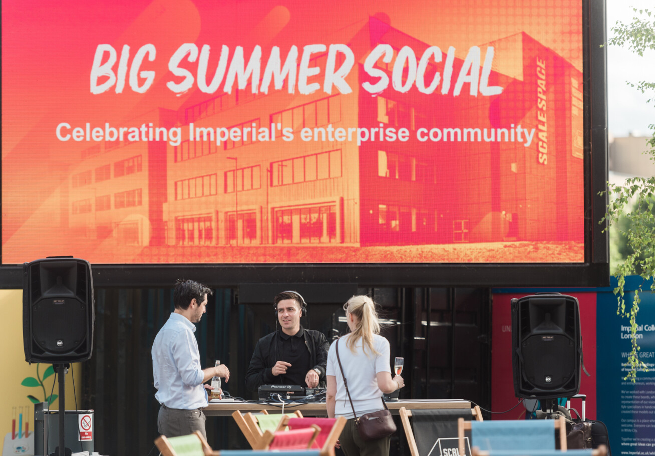 A banner saying Summer Social and people round it