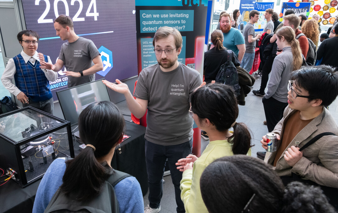A researcher discussing the potential of quantum sensors with attendees