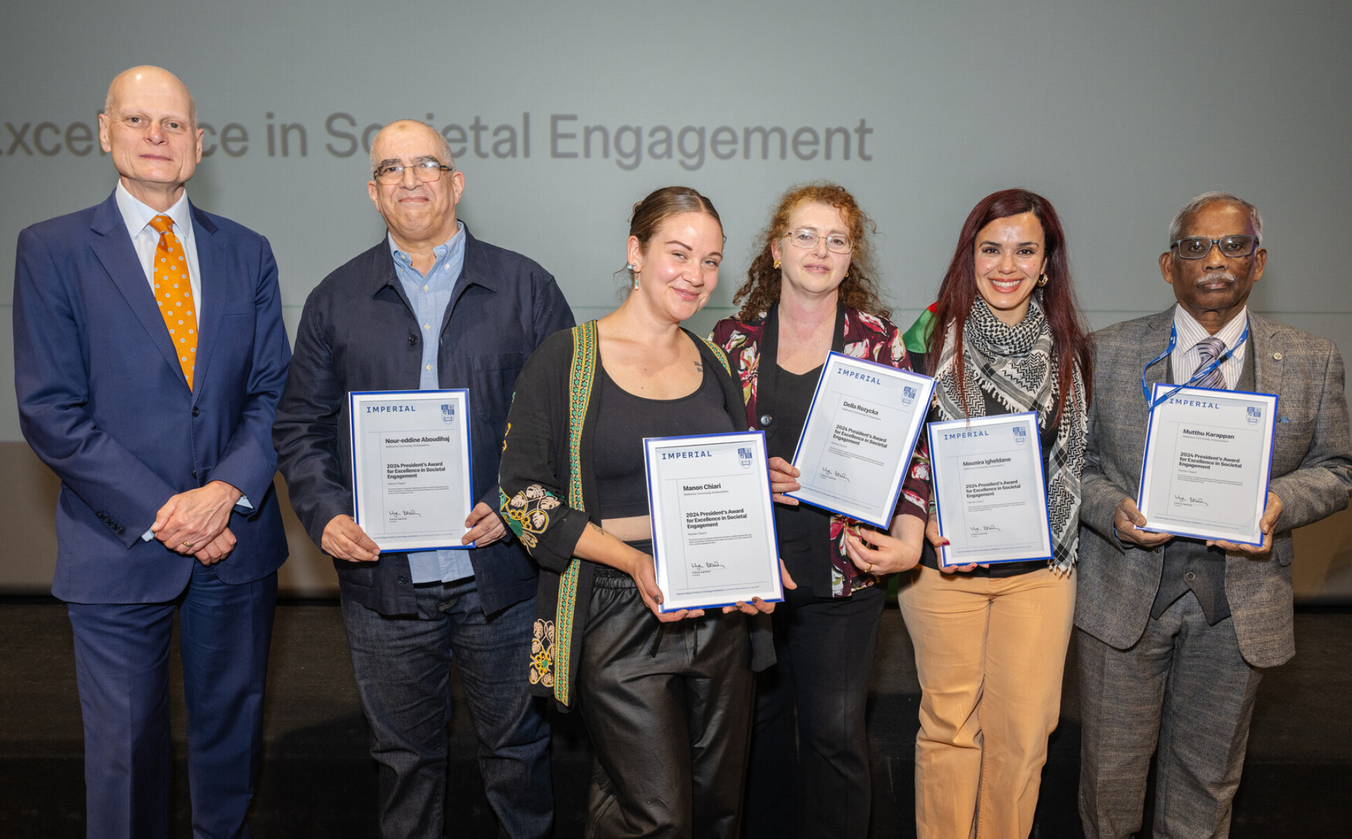 The WellHome Community Ambassadors receiving their award from Provost Ian Warmsley