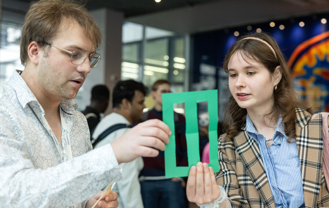 Two people looking at an object from one of the nano exhibits