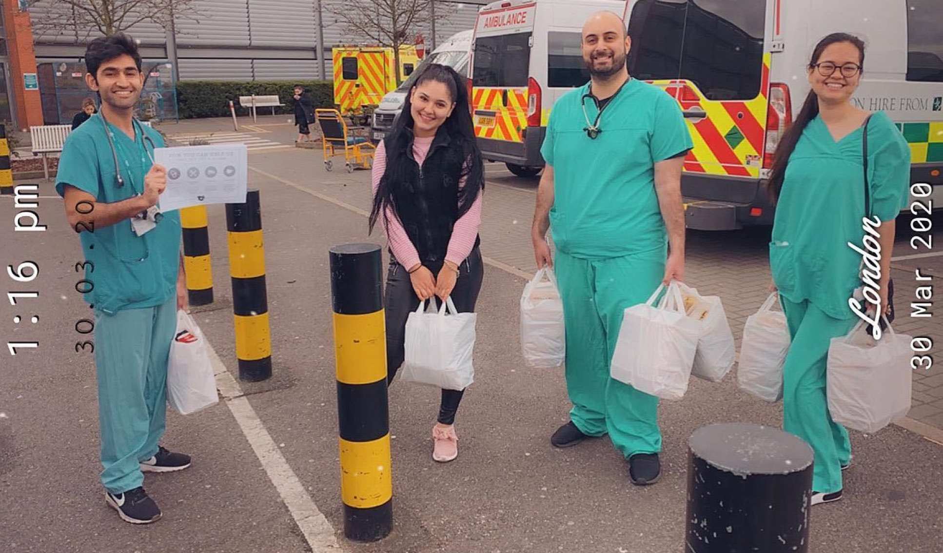 NHS workers collect food parcels with bags in hand
