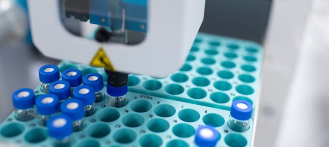 Image of test tubes being used in a tray with a mechanical device.