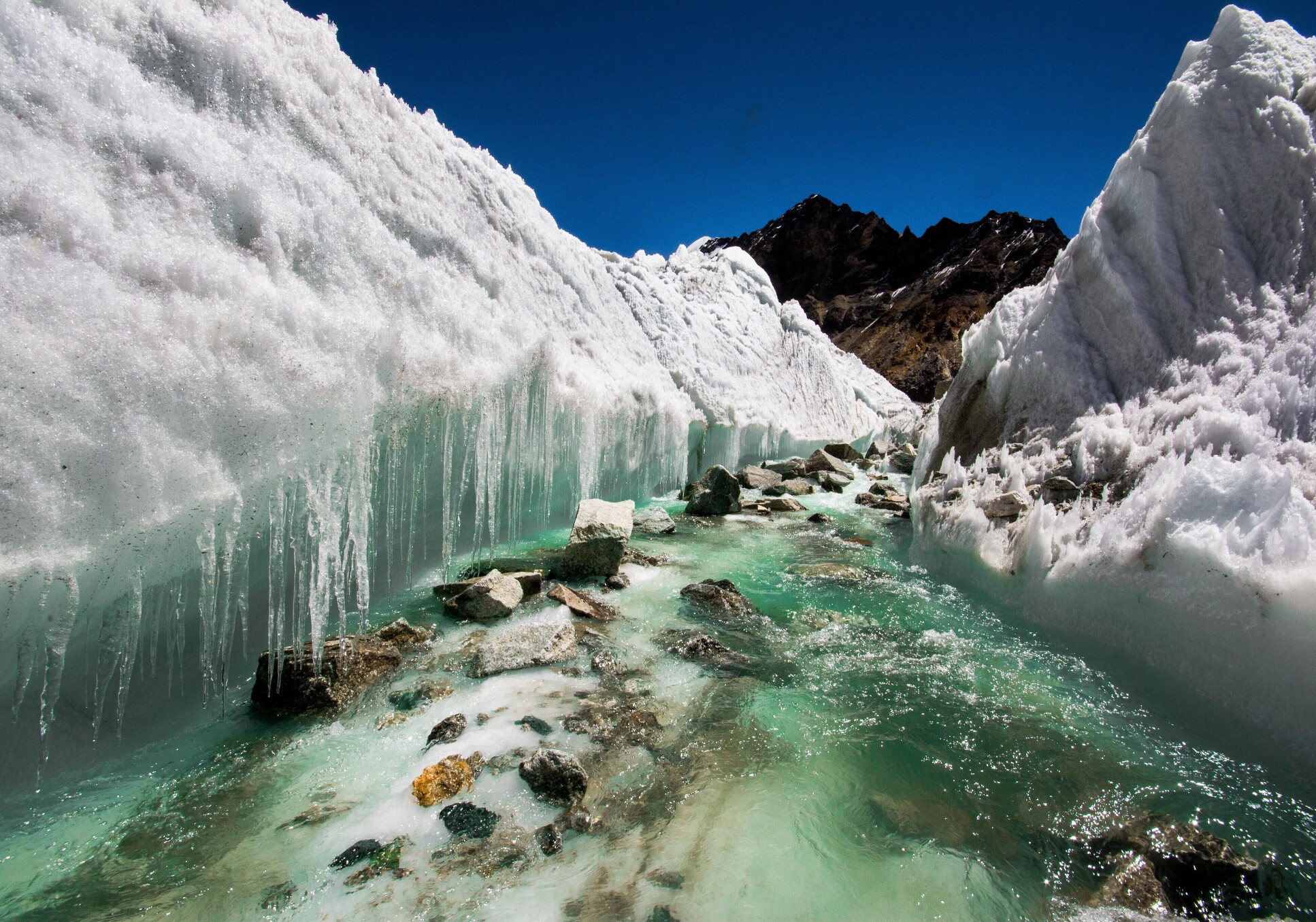 Glacial melt water carving the ice, river source Himalayas India