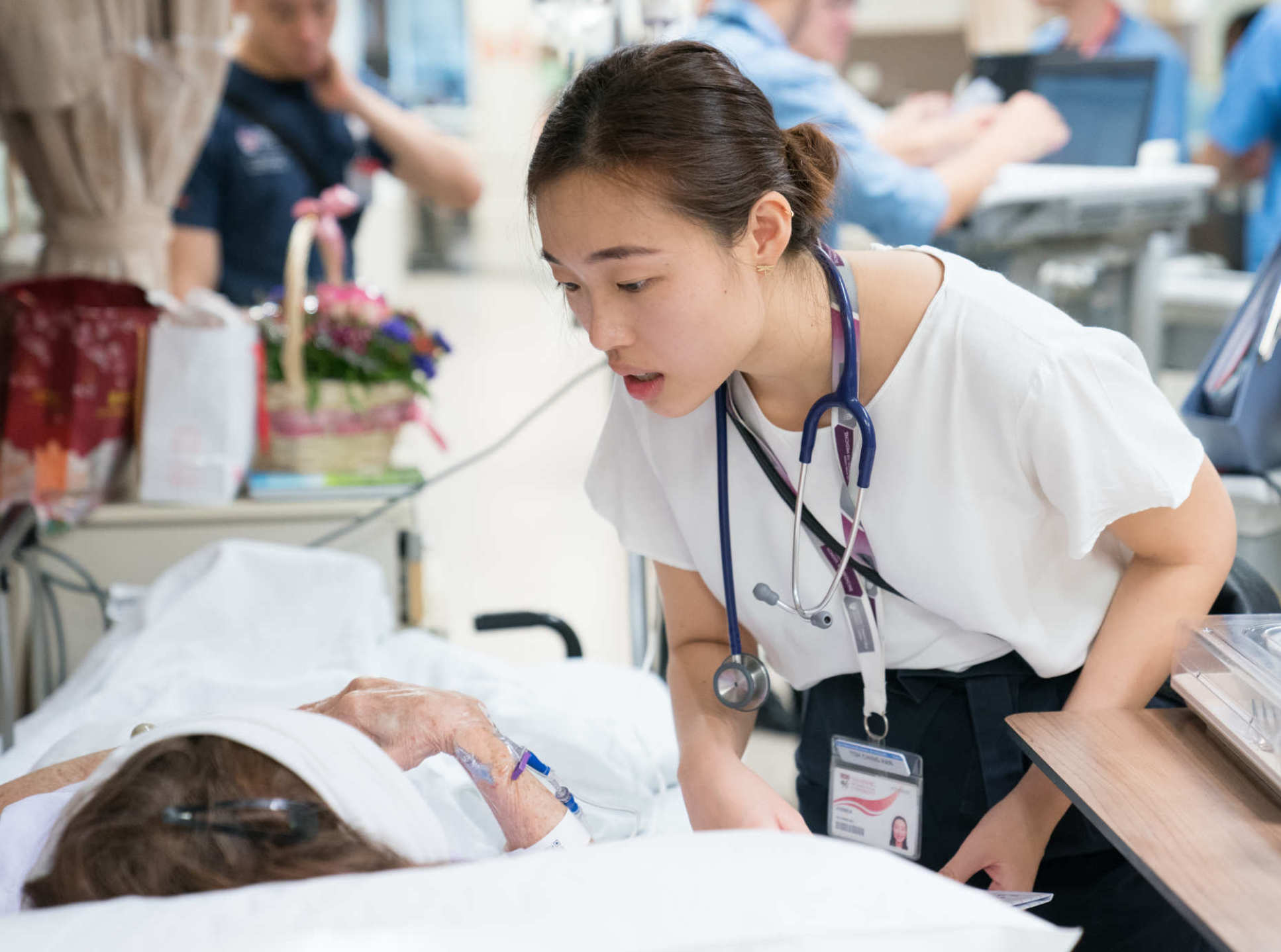 LKCMedicine graduate Ching Han checks on a patient
