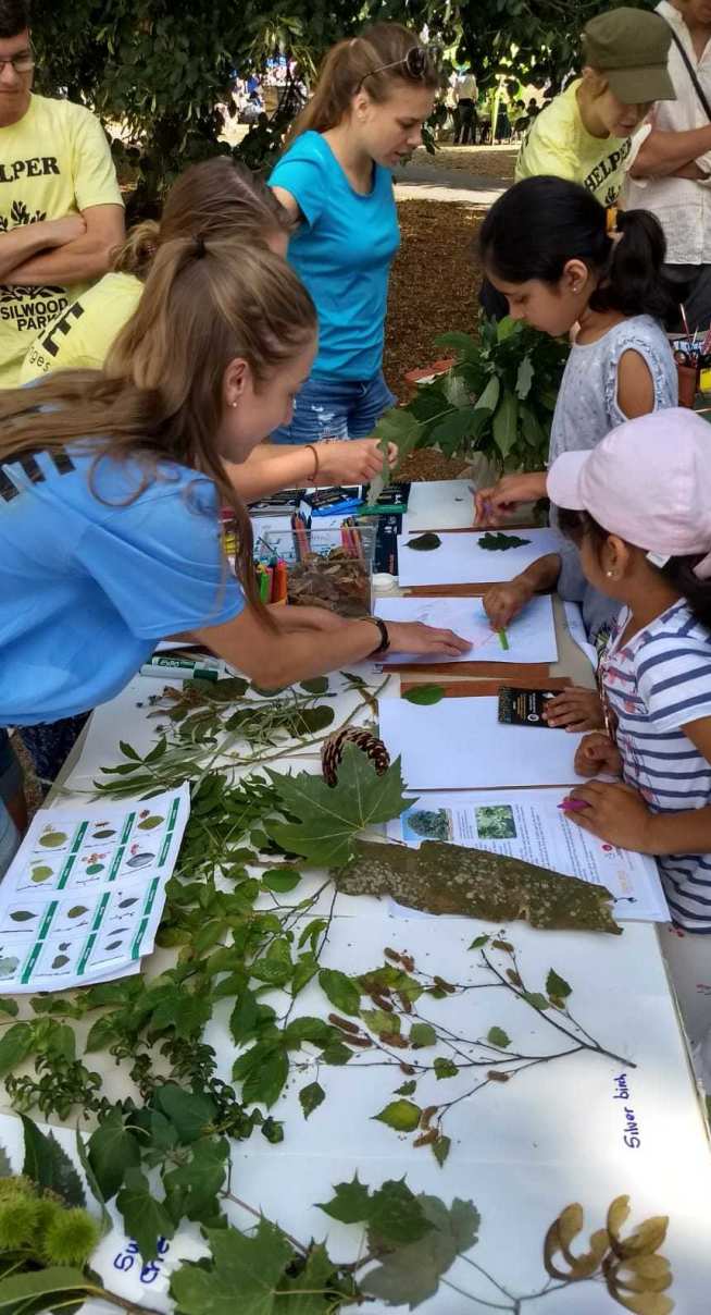 Volunteers show children different plants