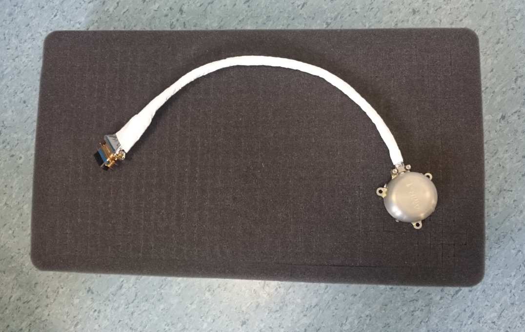Round metal object attached to data cable