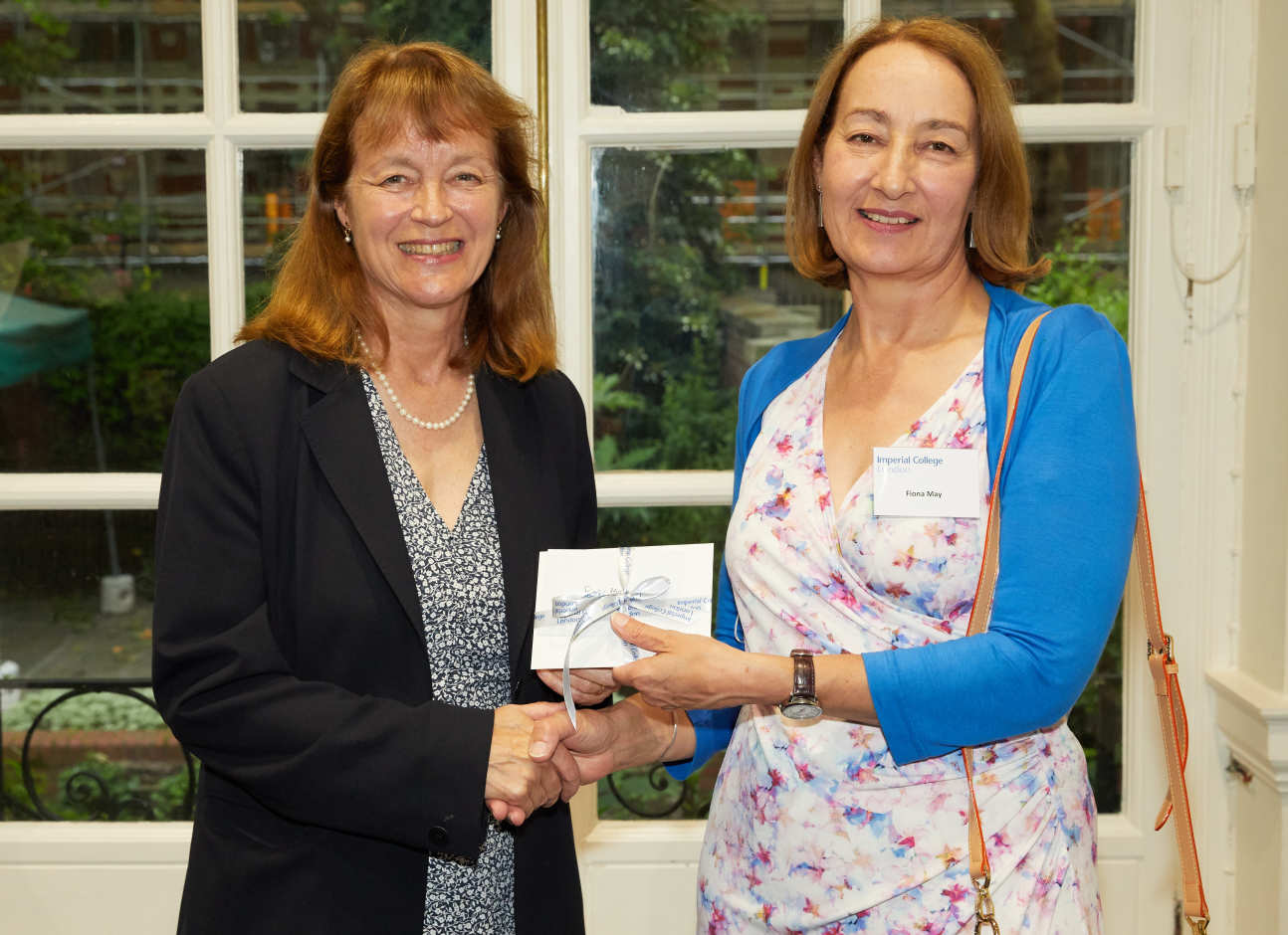 Fiona May receives her prize from President Alice Gast