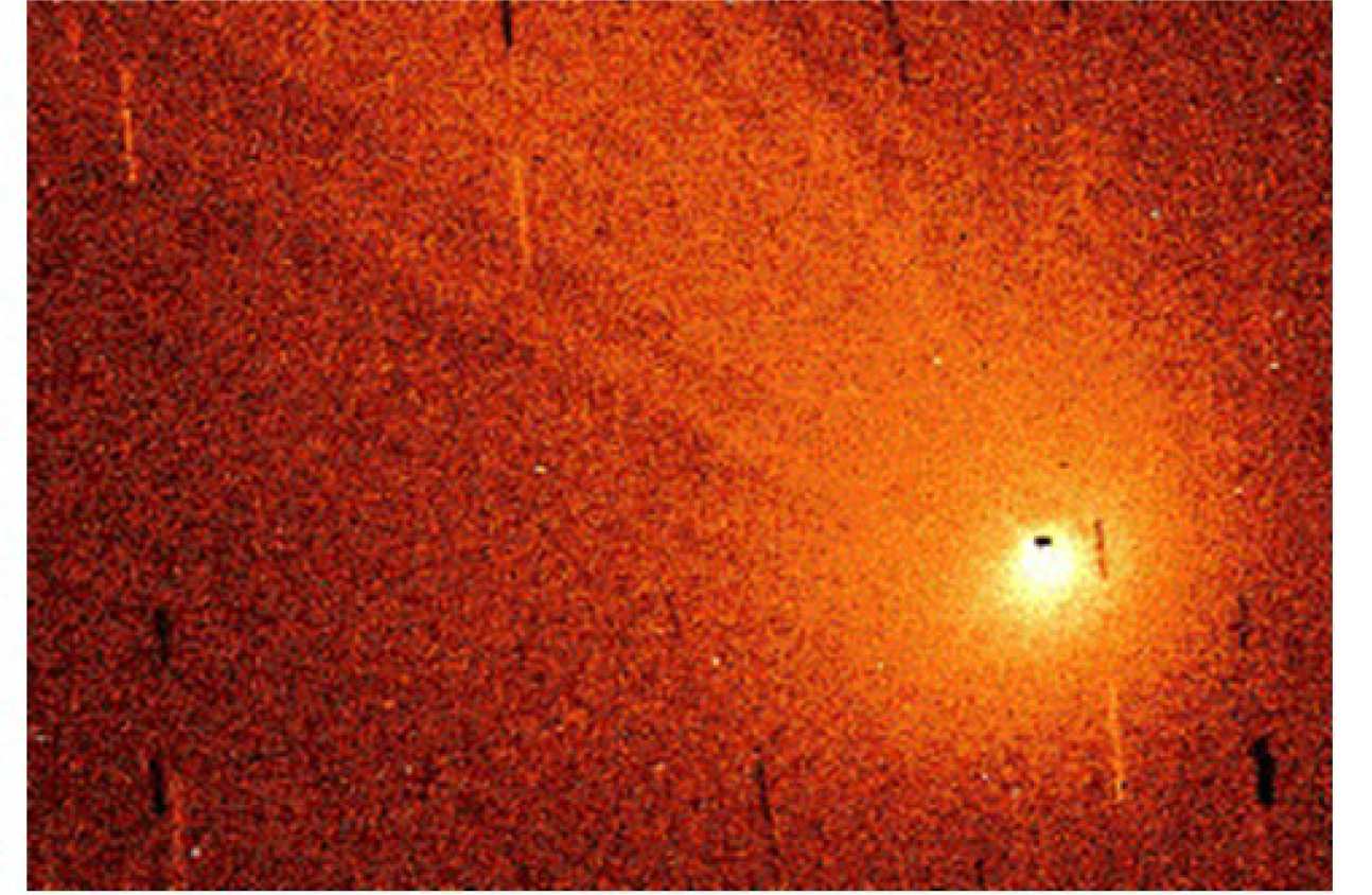 The image below is of Hyakutake obtained with the 0.6m Radcliffe telescope at the University of London Observatory at 23:36 UT on April 1, 1996, covering a region around 159000 by 106300km at the comet. A continuum (dust) image was subtracted from the (H2O+ & dust) image to isolate the light from the water ions. The Sun was towards the lower right, so the solar wind was flowing towards the upper left. The short bright and dark lines are star trails. The broad, diffuse lines are cometary tail rays - a phenomenon which so far has not been satisfactorily explained, but are generally believed to trace the magnetic field lines of the solar wind as it is convected through the comet.