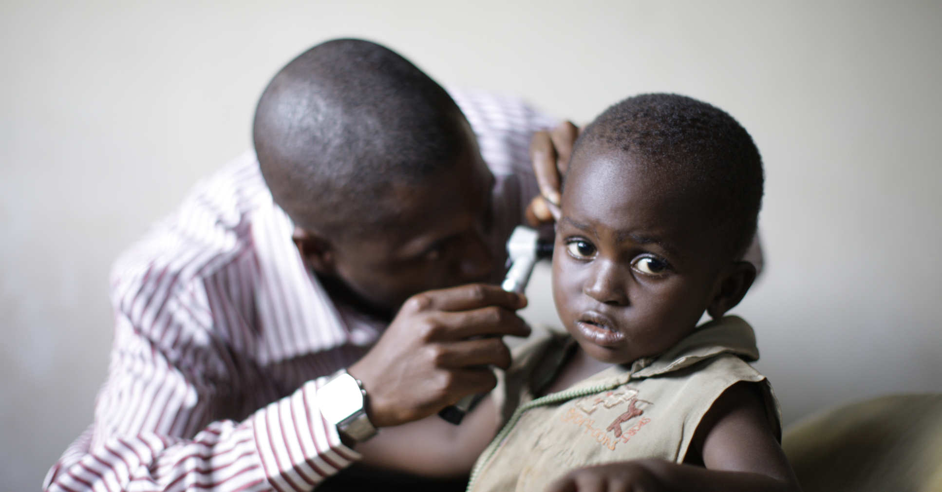A young African child getting examined by a doctor