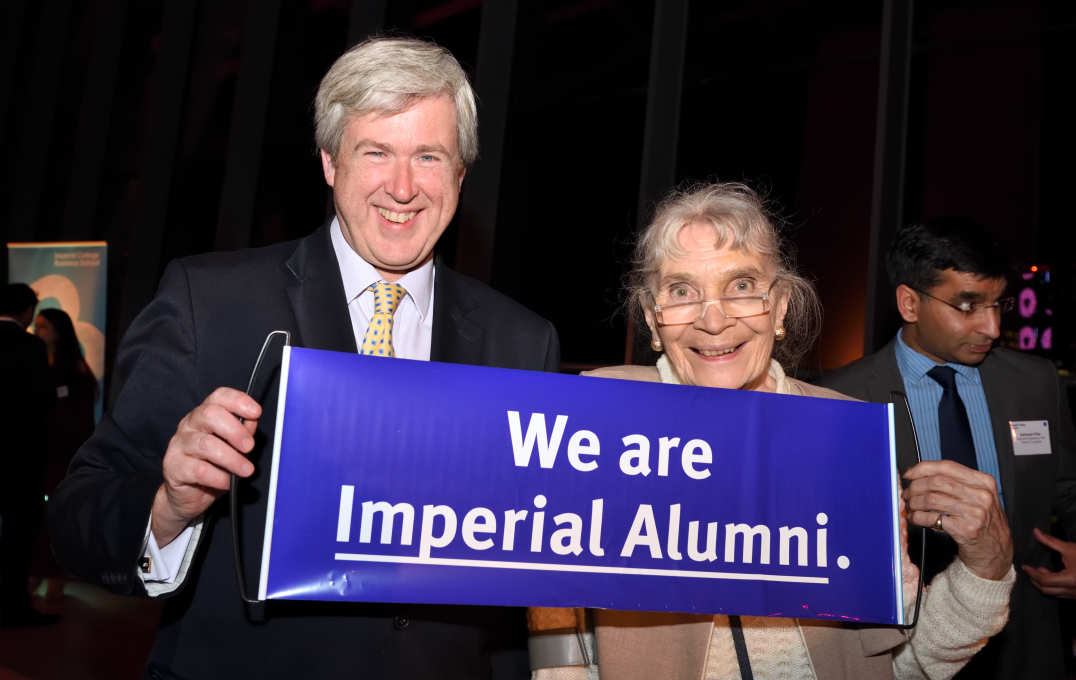 Alumni holding an Imperial banner