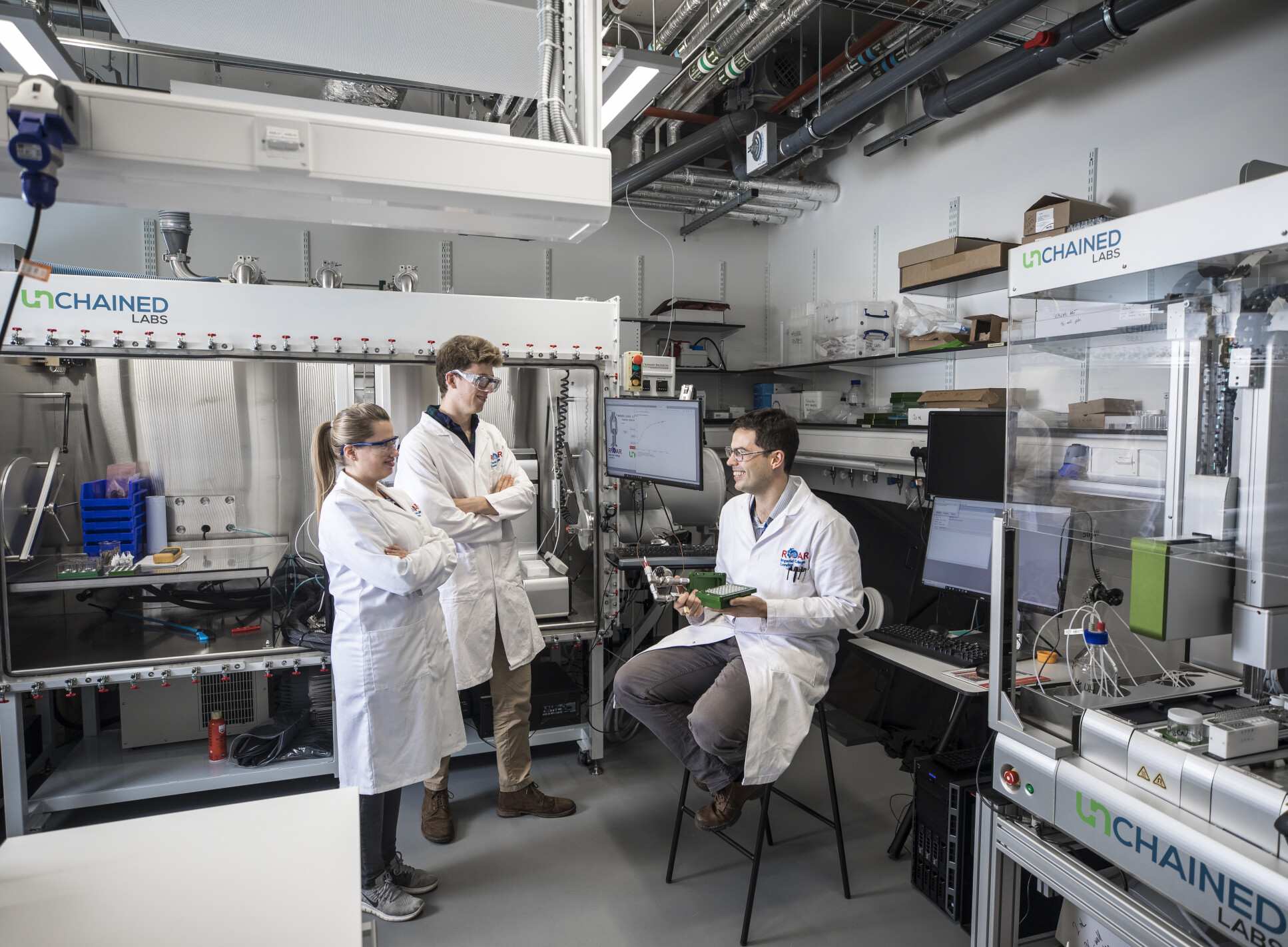 Three people in a laboratory