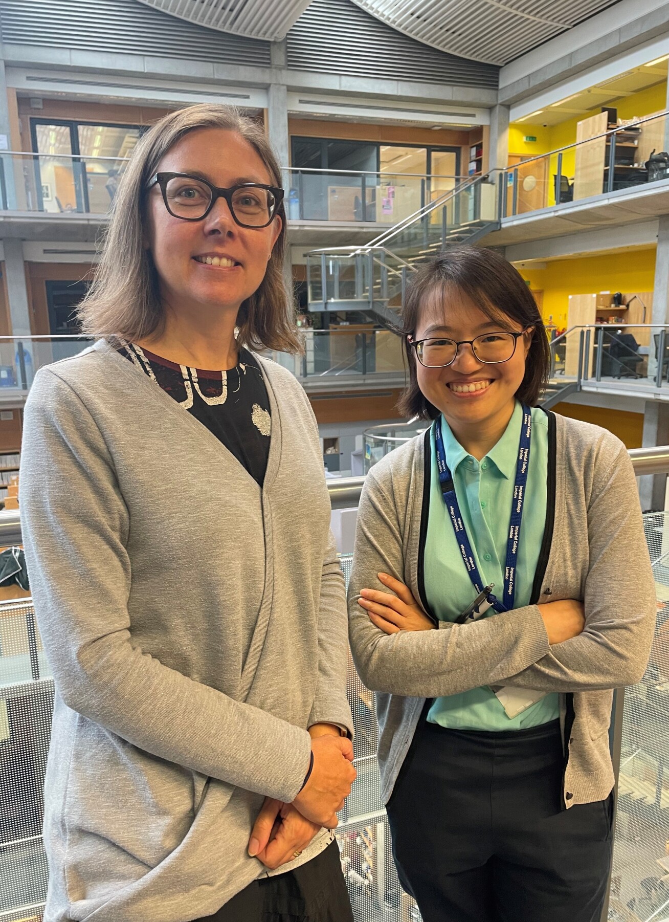 Two women in front of labs