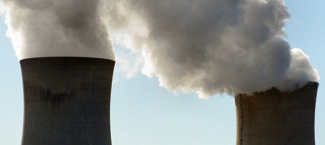 Two power plant chimneys expelling steam