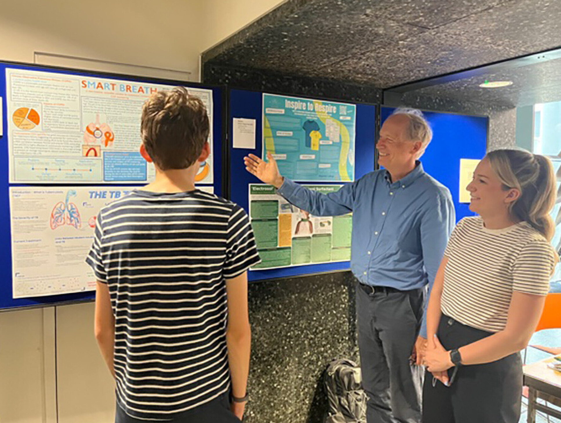 Dorian Haskard and Courtney Chatterton-Bartley discuss last year’s winning posters with a visitor.