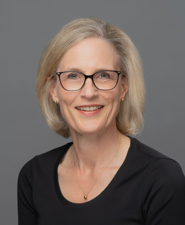 head shot of a smiling woman with blonde hair and glasses