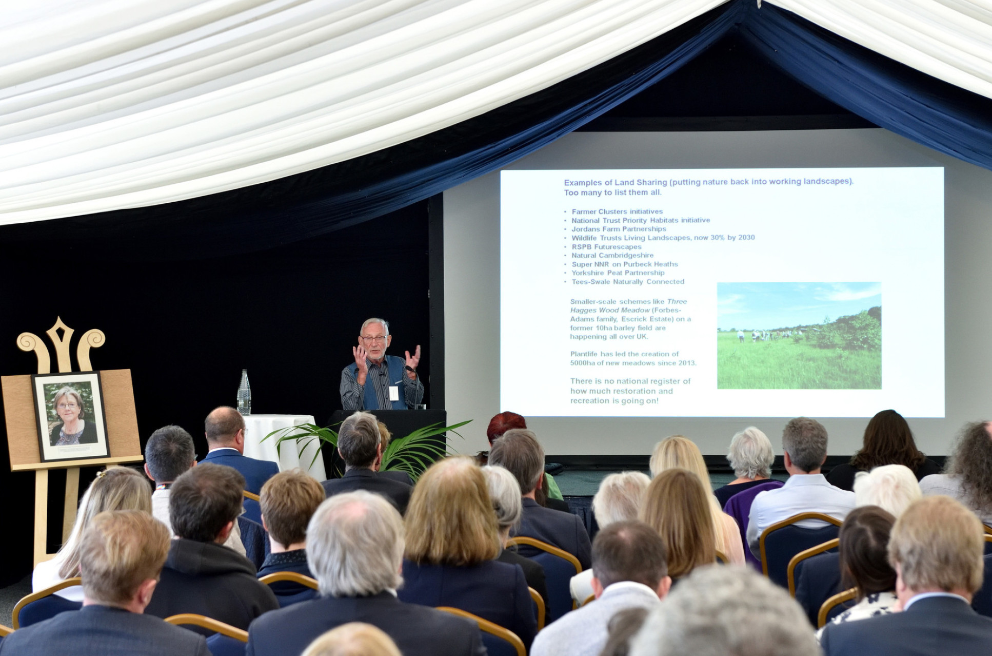 Sir John Lawton presenting to the audience