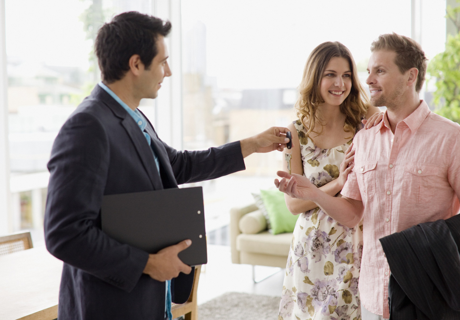 Young couple receiving keys to a property