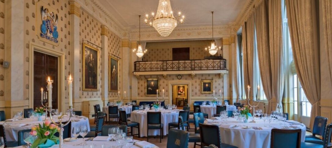 An official photo of Great Saddlers Hall - a grand dining room pictured in warm lighting 